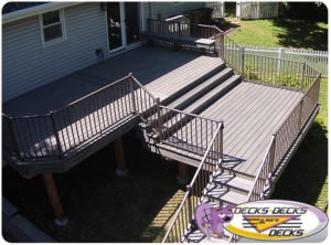 An aerial view of a second story deck with stairs to the lawn