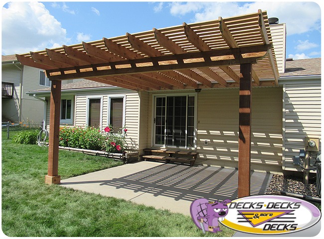 A pergola over a cement patio