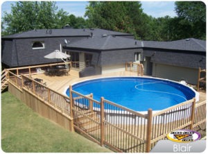 A low maintenance pool deck with a table, chairs, and umbrella