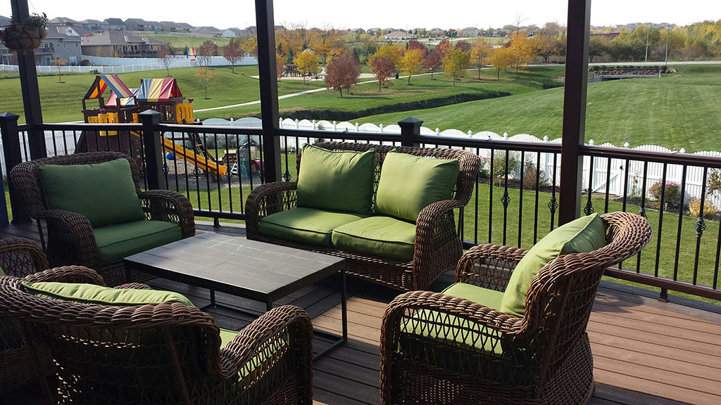 Ralston composite deck furnished with sectional sofa, coffee table, and string lighting